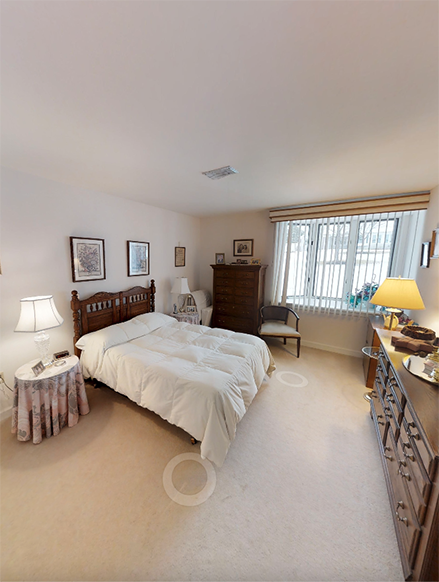 Spacious bedroom filled with light in an Independent Living, One Bedroom Cottage.